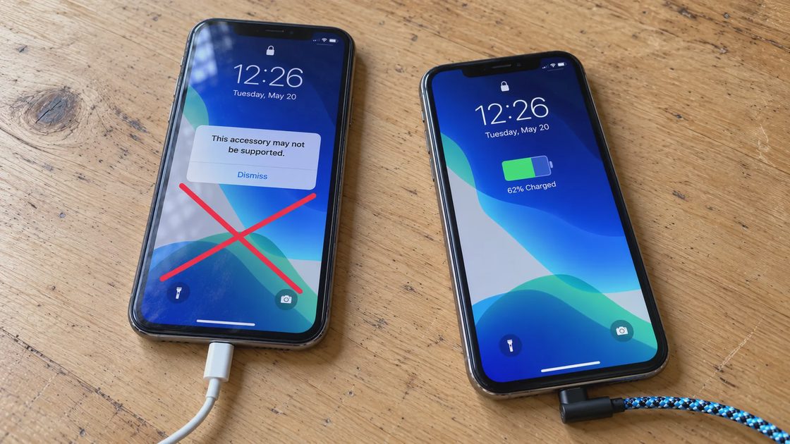 Lightning Accessory Warning and Normal Charging Two iPhones on a wooden table: one shows an accessory warning with a white straight cable, while the other displays charging status with a blue braided right-angle cable.